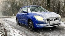 Blue Suzuki Swift covered in snow