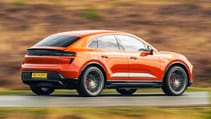 Porsche Macan driving on a road