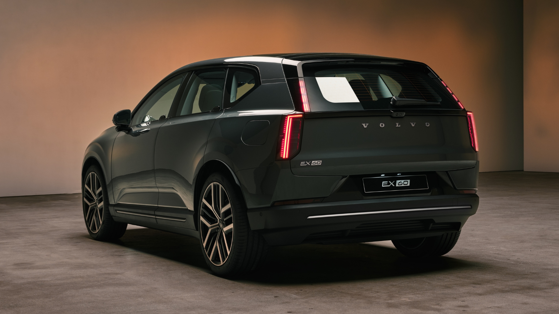 Volvo EX60 set against a studio background, pictured from the back