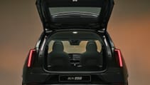 Volvo EX60 with it's boot open, set against a studio background, pictured from the back