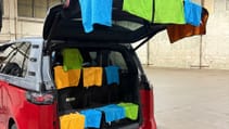 Volkswagen ID.Buzz with clothes hanging from inside the boot