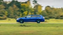 Volkswagen Passat Estate driving on a road surrounded by greenery