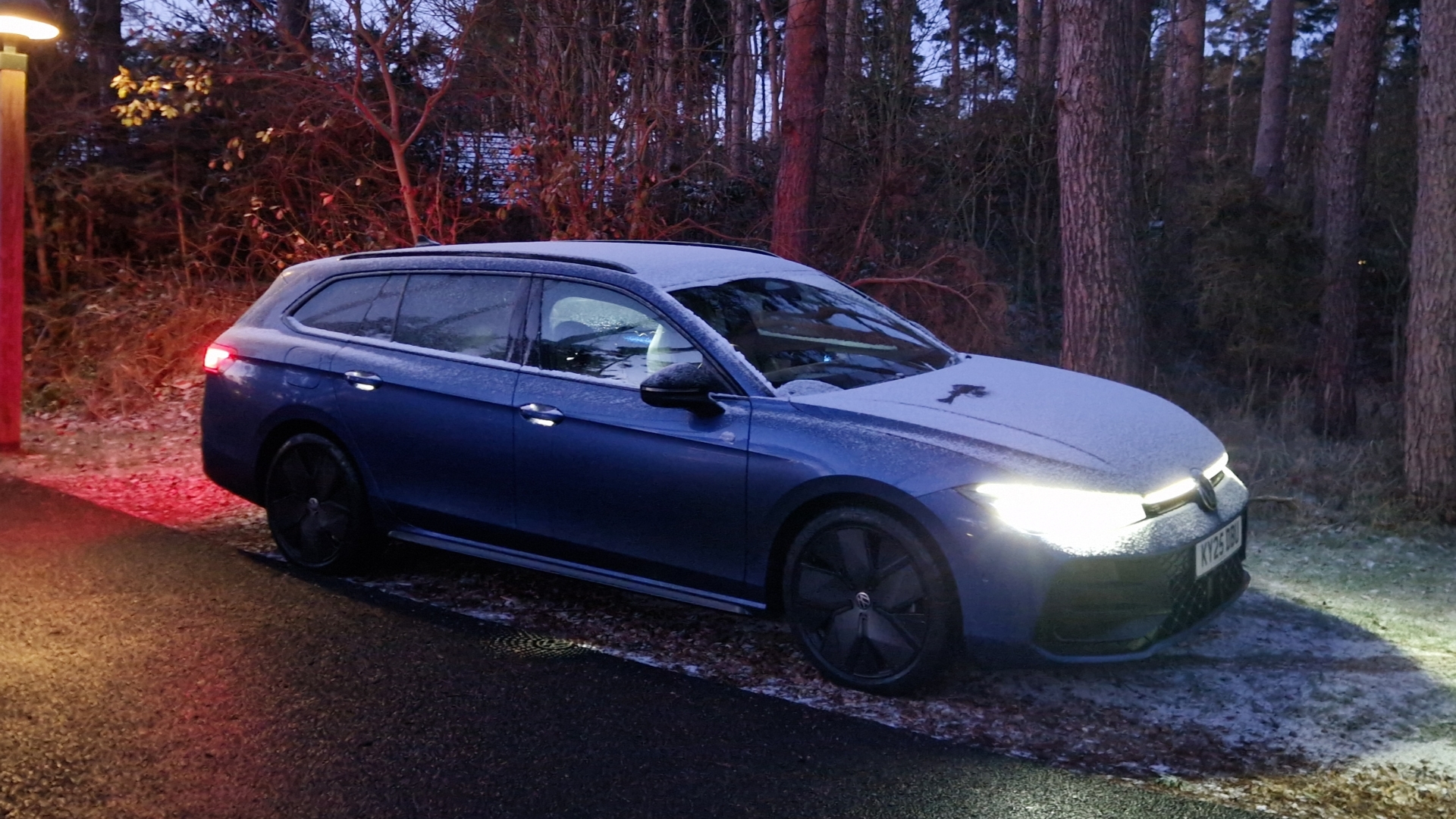 Volkswagen Passat Estate parked outside on a snow evening