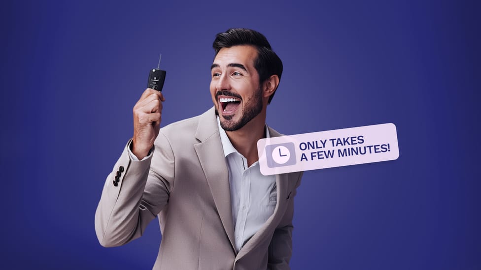 A man looking happy holding a car key