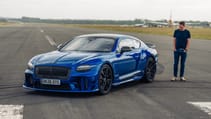 Bentley Supersports front three quarters with driver standing next to it