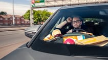 The writer of the feature looking bored behind the wheel