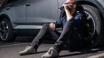 The writer of the feature slumped against the side of the car