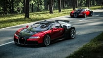 Bugatti Veyron driving on a quiet country road lined with tall trees, pictured from the front