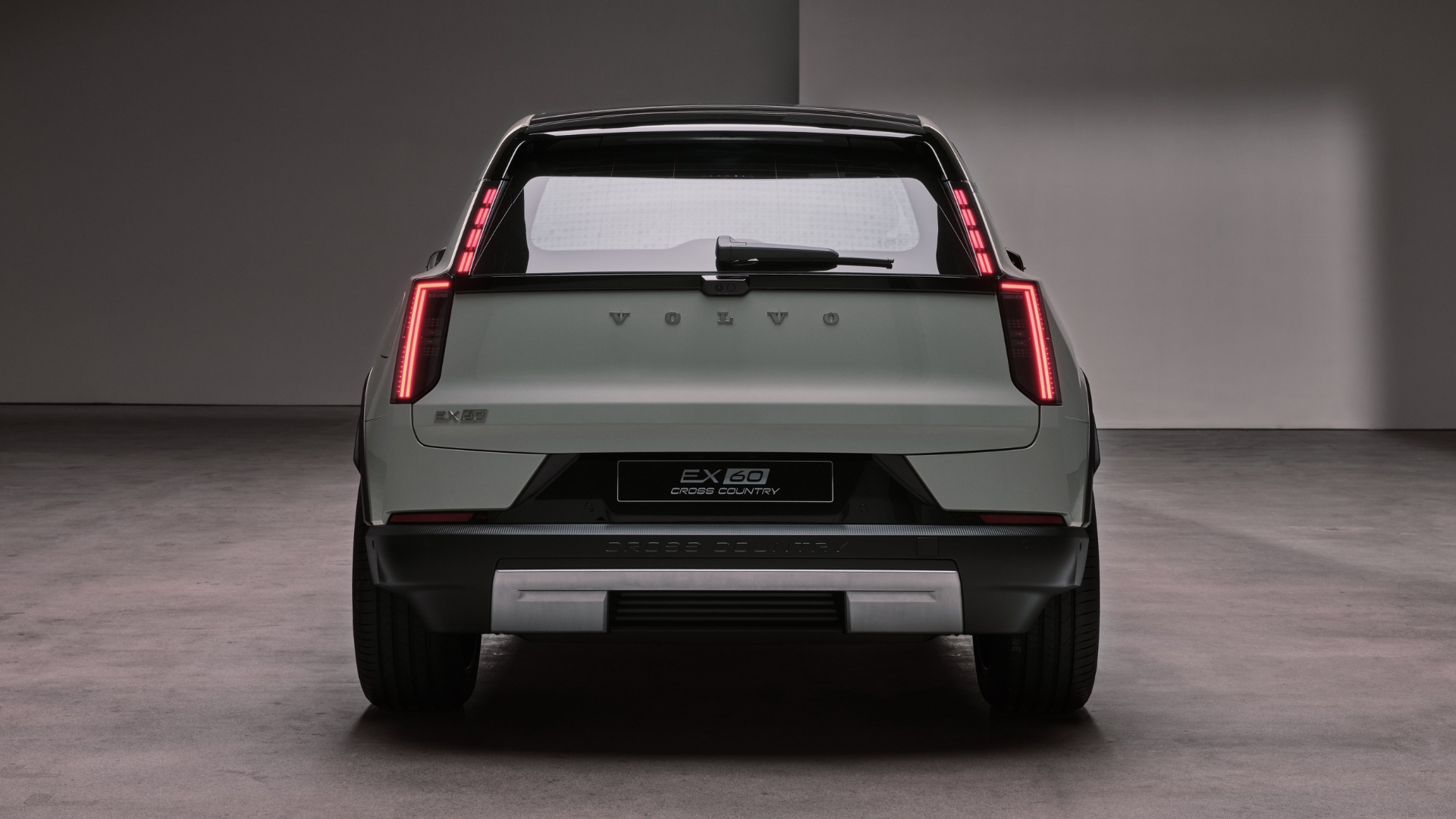 Volvo EX60 Cross Country set against a studio backdrop, pictured from the back