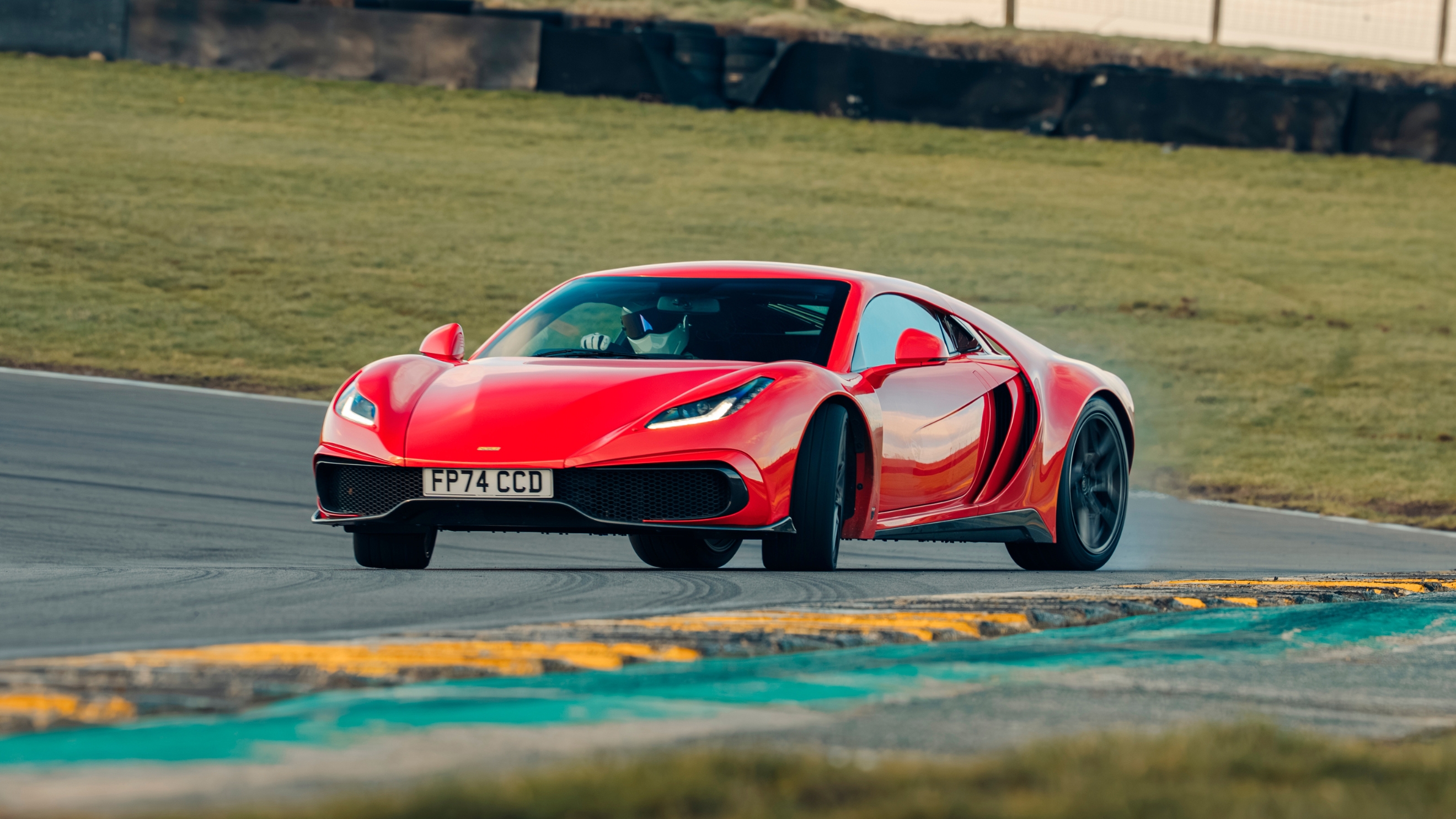 Noble M500 driving on a track pictured from the front