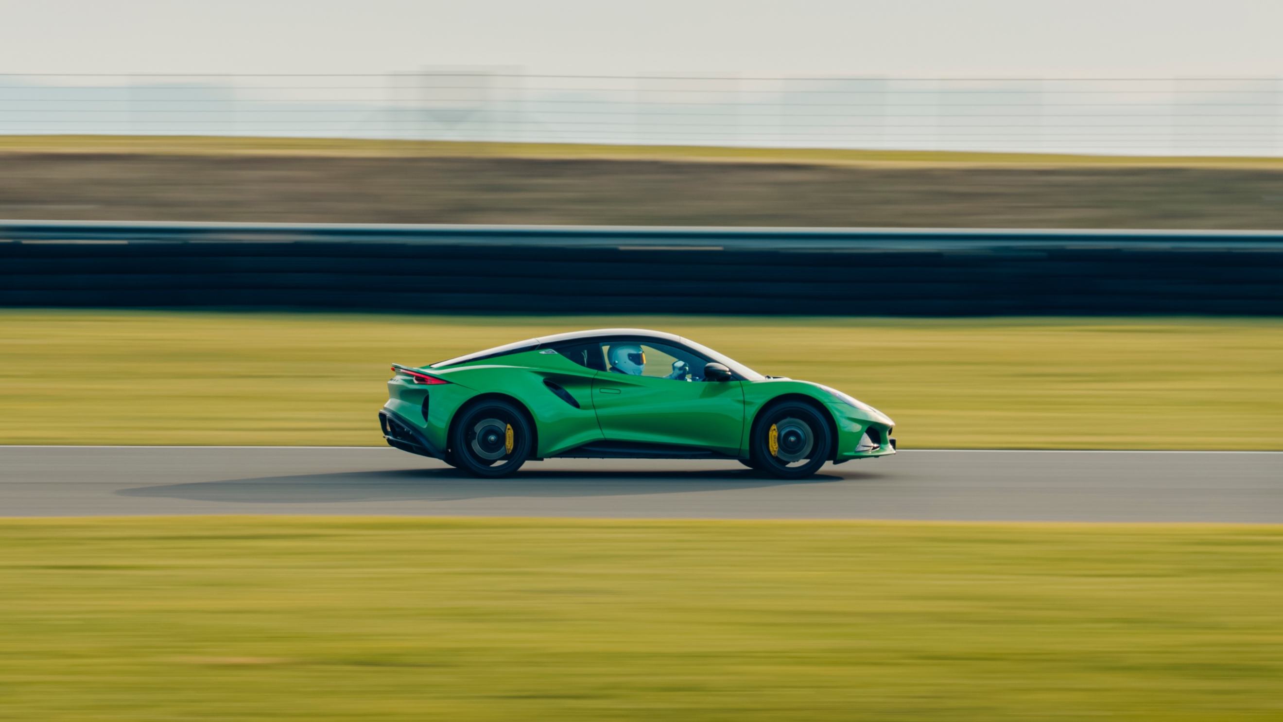 Lotus Emira pictured from the side driving at speed