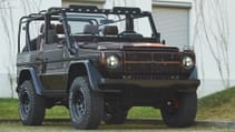 expedition-motor-company-rubellite-red-wolf-front-passenger-side-low-angle-day-time-view.jpg