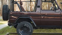 expedition-motor-company-rubellite-red-wolf-rear-passenger-wheel-side-view-day-time.jpg