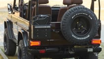 expedition-motor-company-rubellite-red-wolf-rear-spare-tire-view-day-time.jpg