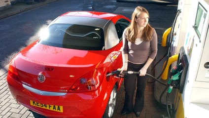 Woman refuels red car