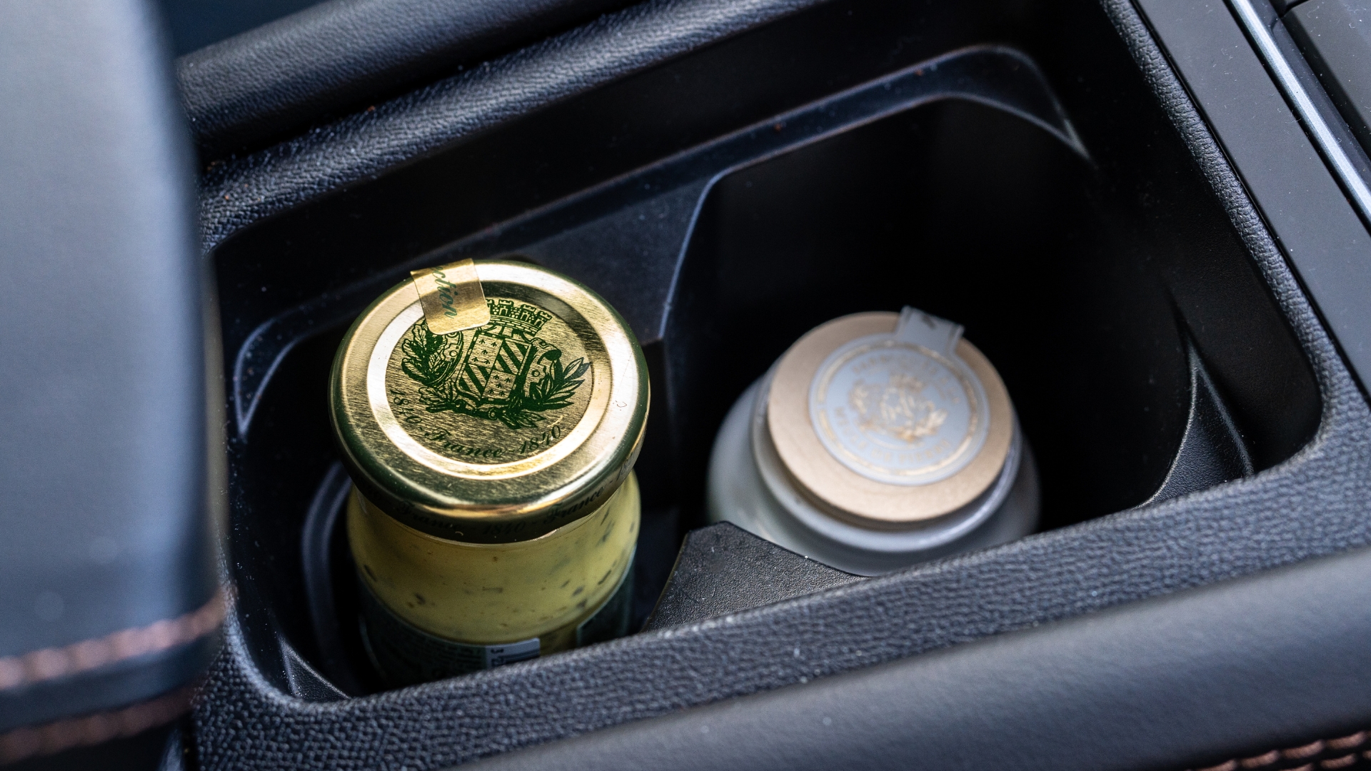 Close up of two jars inside the cup holders of Cupra Leon