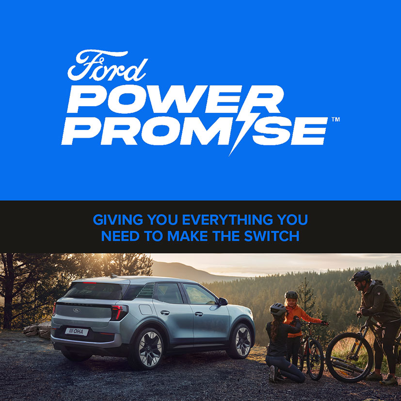 Ford Power Promise™ | Giving you everything you need to make the switch | New All-Electric Ford Explorer® car in Arctic Blue parked, with a family of three about to ride their mountain bikes