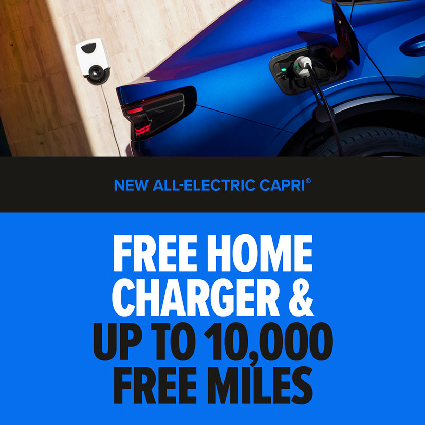 New All-Electric Ford Capri® car in blue on charge | Free home charger & up to 10,000 free miles