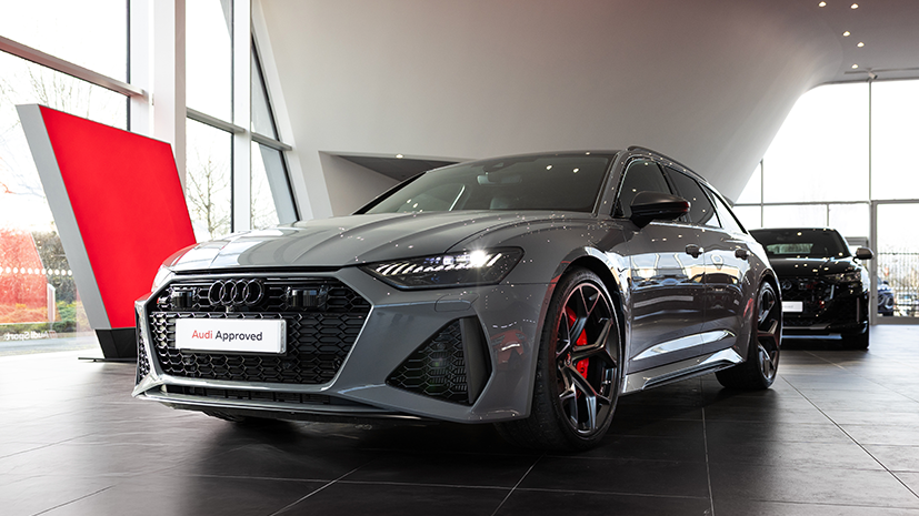 Sleek grey Audi RS car displayed in a modern showroom with large windows