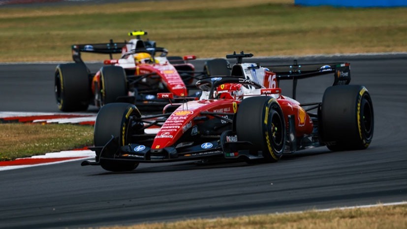 Two Scuderia Ferrari HP Formula cars being driven on a F1 track