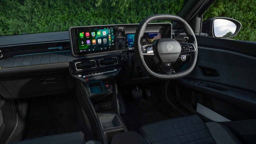 Modern car interior of the Renault 4 E-Tech electric car, with a sleek, digital dashboard featuring a large touchscreen and a multi-function steering wheel. Plush seating, set against outdoor greenery