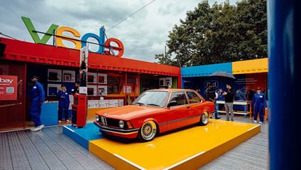 An orange car in the eBay Garage at the 30th edition of the Goodwood Festival of Speed