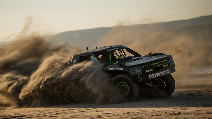 Rocking-across-desert-with-Baldwin,-Monster-Energy-truck