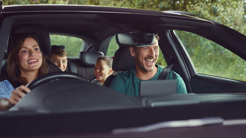 A family of four in an electric car
