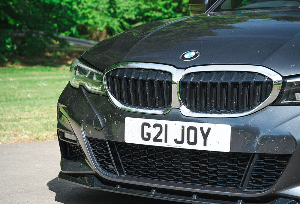 A close-up of the front of a black 2022 BMW 330D Touring
